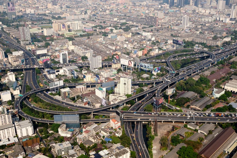Aerial perspective showcasing Bangkok's intricate expressway system and urban landscape.