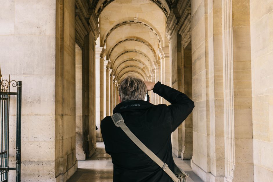 A photographer captures the beauty of a historical archway in Paris, France.