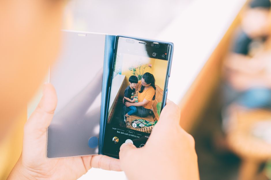 A touching moment between mother and son captured on a smartphone, emphasizing love and family bonds.