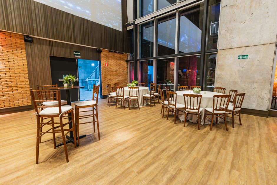A tastefully decorated hall with tables and chairs set for an event.