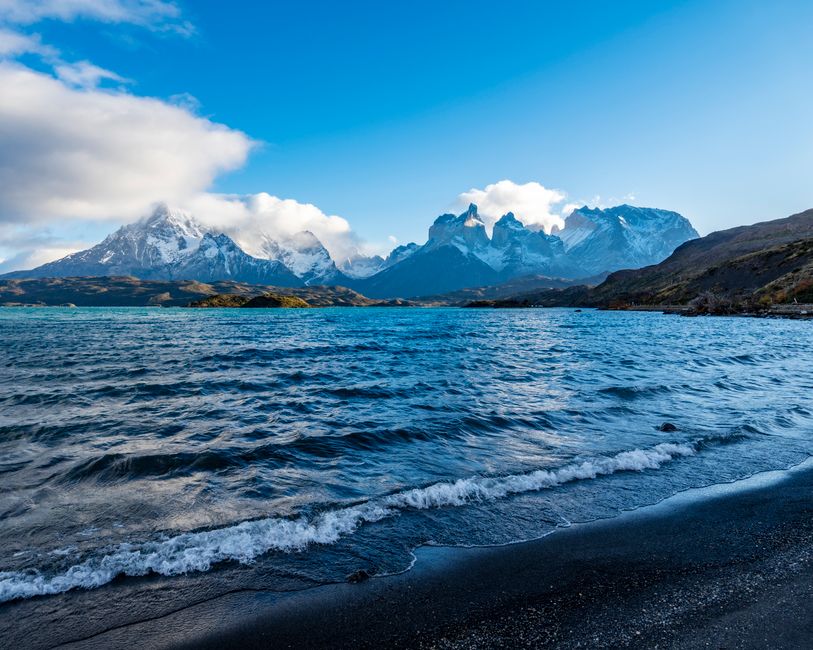 Stunning landscape of Torres del Paine with snow-capped peaks and a mountain lake in Chile.