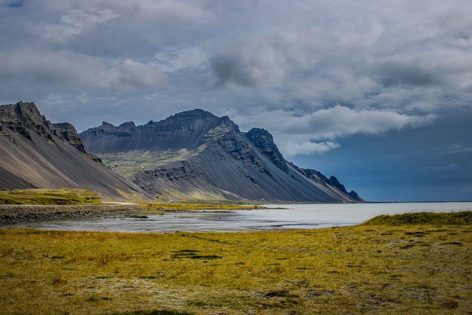 Explore the rugged beauty of Iceland with this stunning view of majestic mountains by the sea.