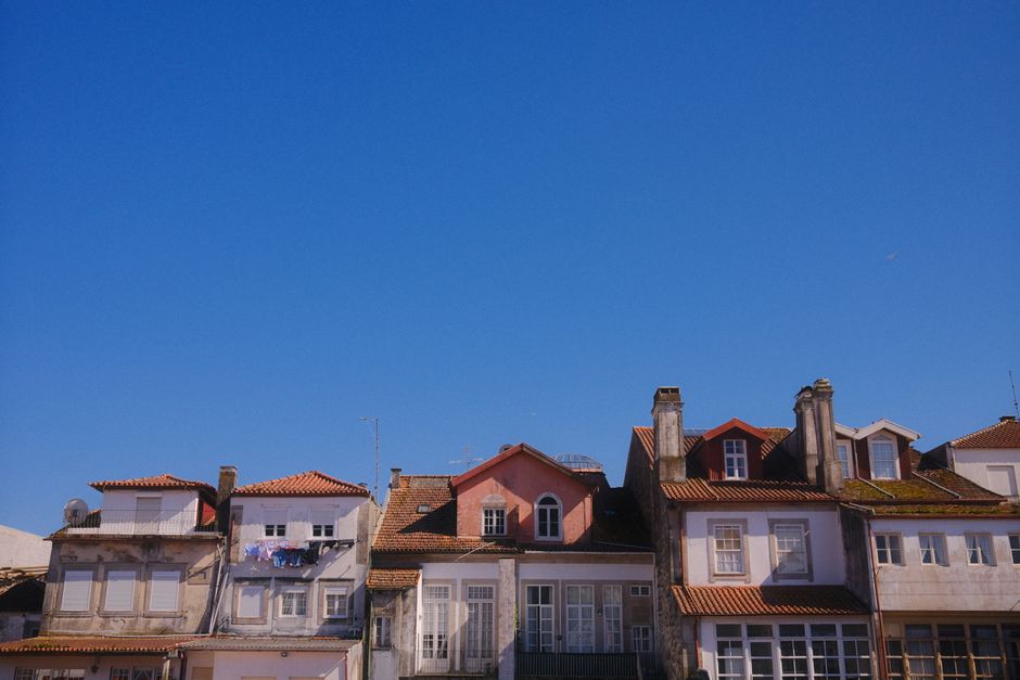Picturesque view of colorful rooftops against a clear blue sky in Viana do Castelo, Portugal.