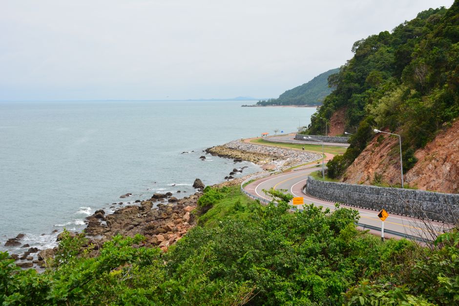 Winding coastal road along the sea in Chanthaburi, Thailand, offering stunning ocean views.