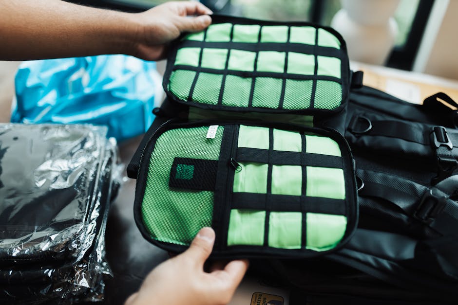 Close-up of hands organizing a travel luggage with packing cubes for efficient packing.