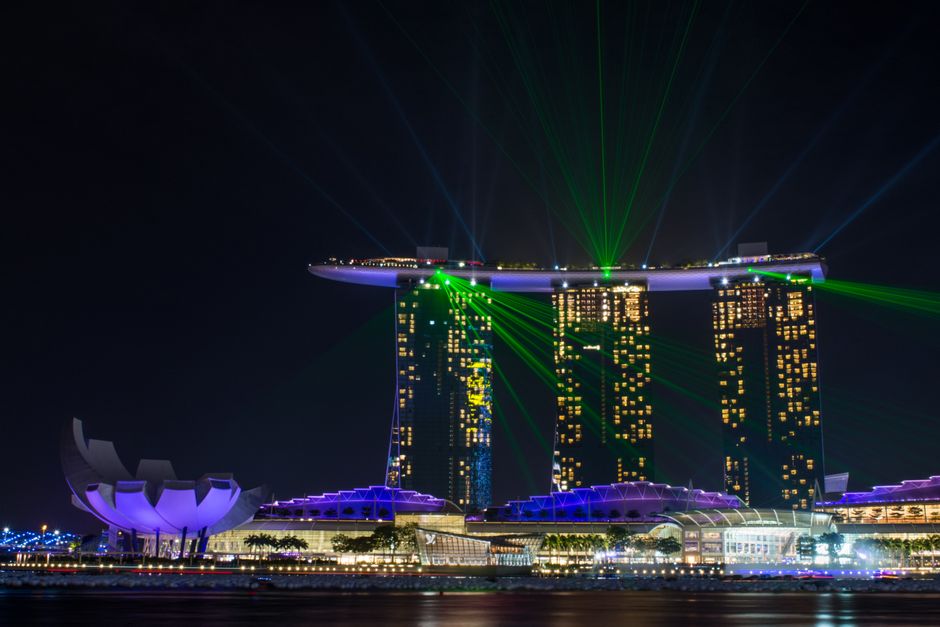 Stunning nighttime shot of Marina Bay Sands with dazzling light show in Singapore.