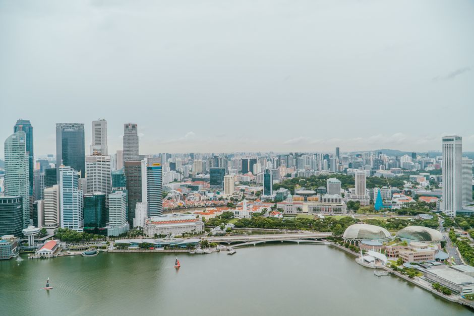 Stunning aerial view of Singapore's skyline and Marina Bay, with iconic landmarks and modern architecture.